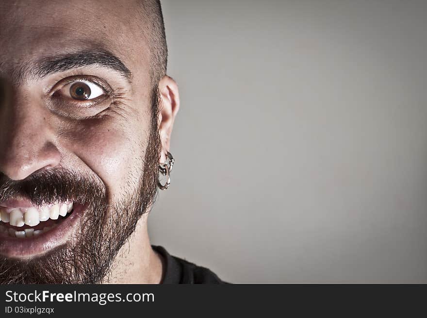 Mid-frontal portrait of smiling man on grey background