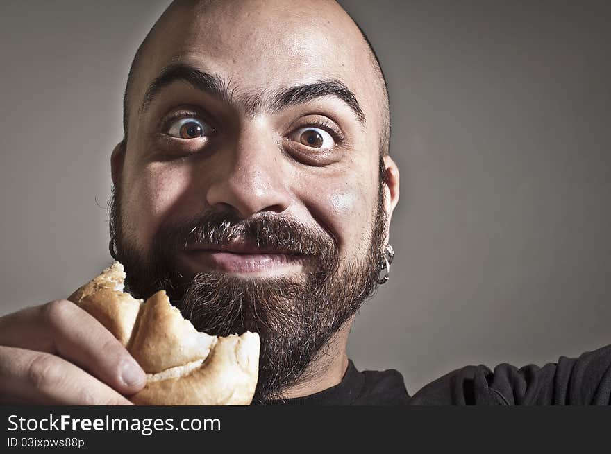 Happy man with bread in his mouth