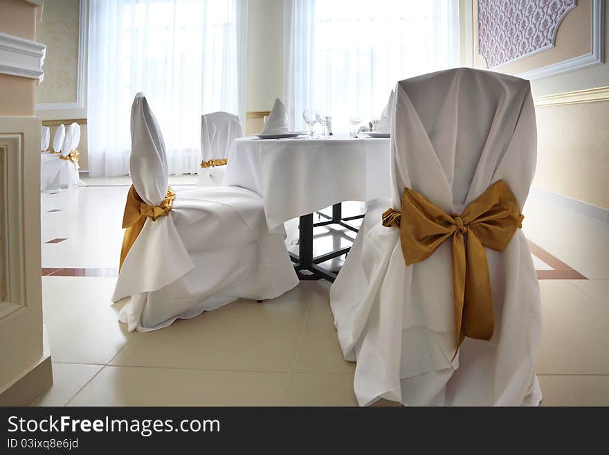 Interior of the restaurant with white table and chairs. Interior of the restaurant with white table and chairs