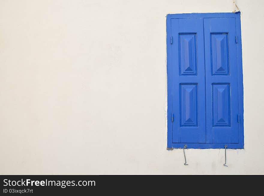 Old blue window and white wall