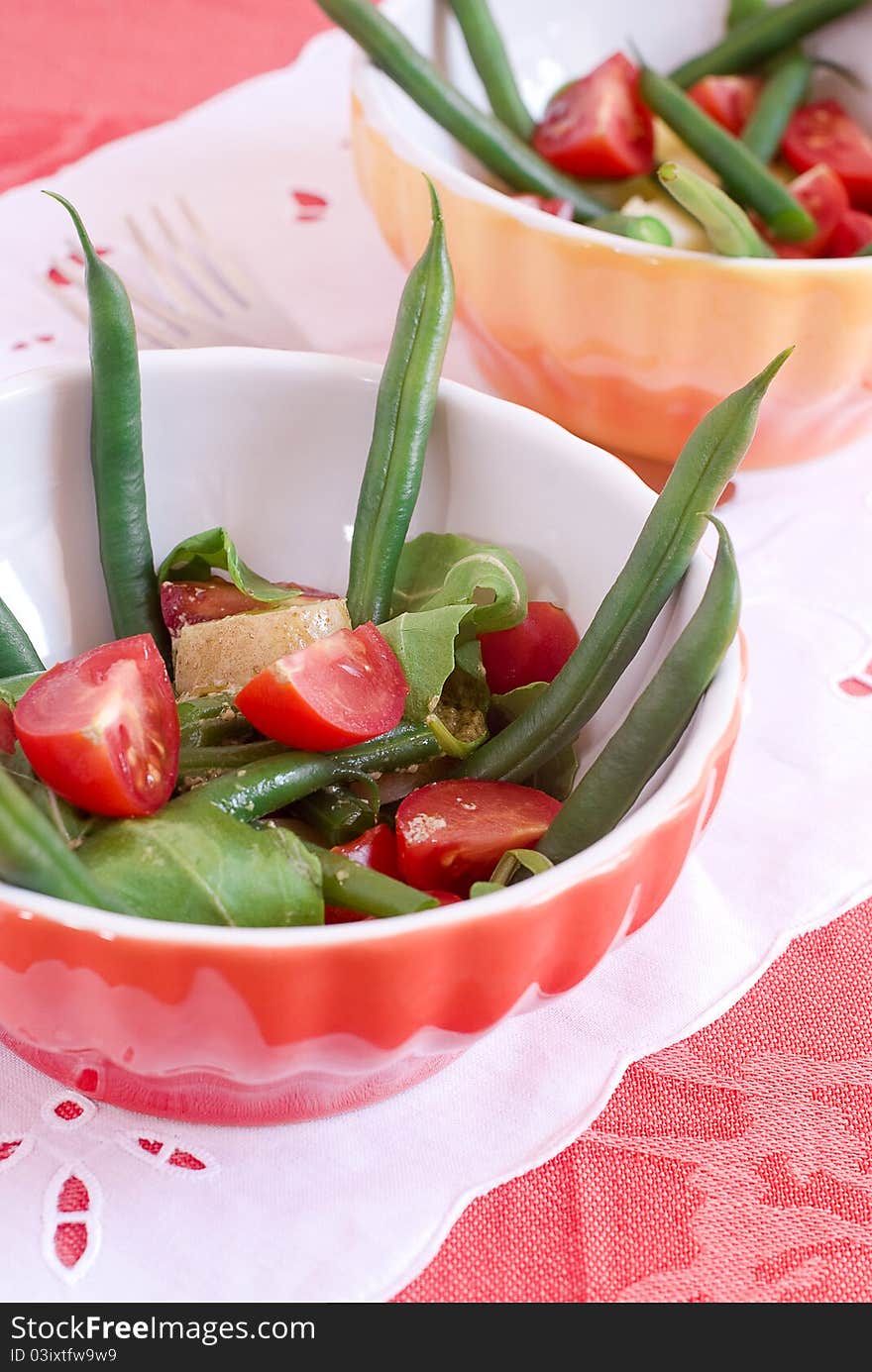 Salad with bean, tomatoes, rocket and potatoes