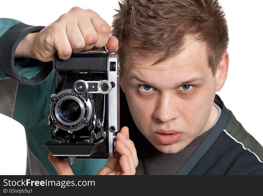 A young man is focused photographing old camera