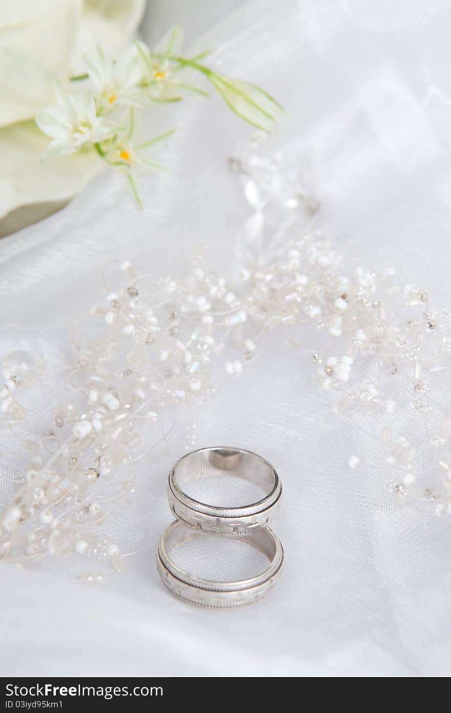 Wedding rings and beads on a veil