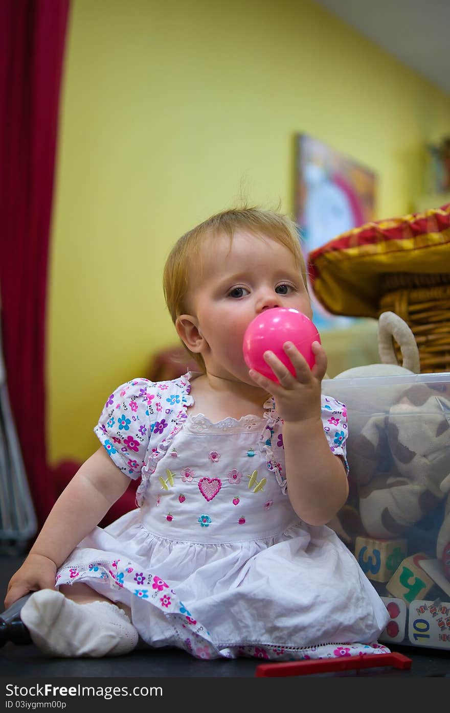 Little baby girl playing in nursery room. Little baby girl playing in nursery room