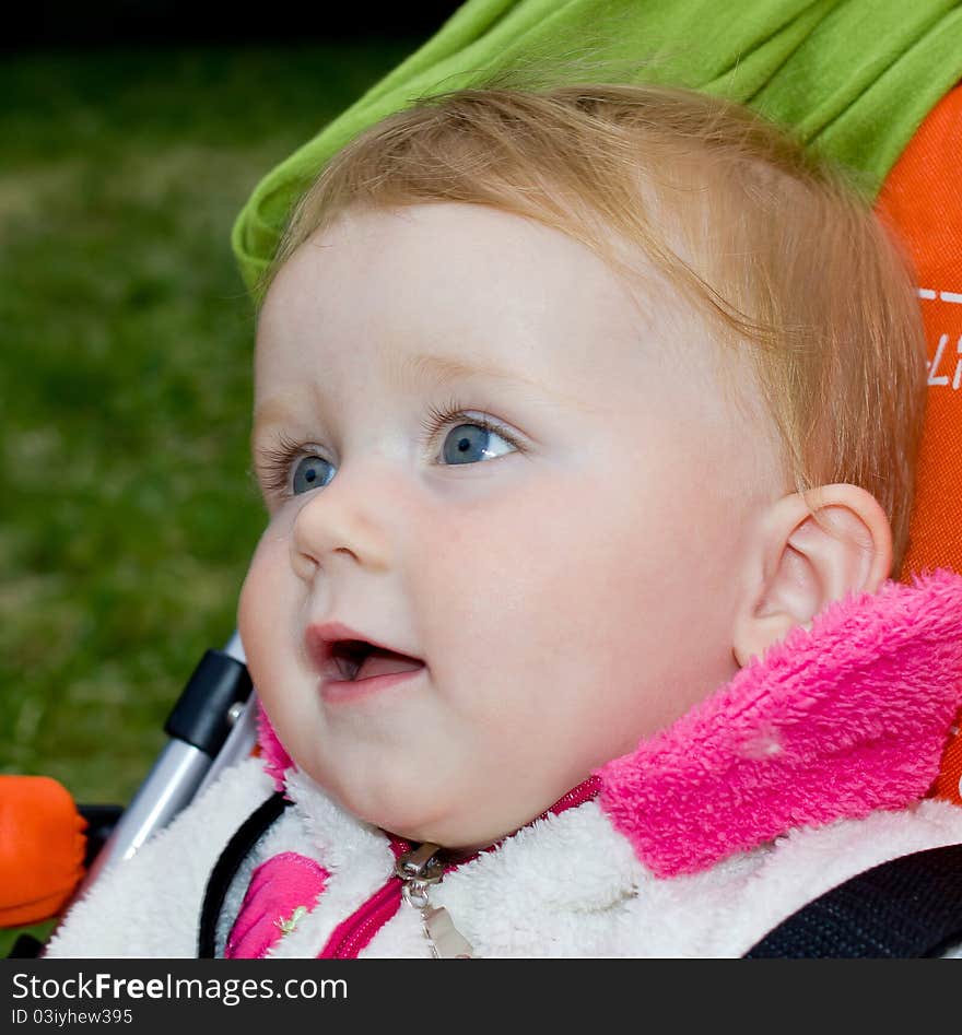 1 year old girl sitting in baby carriage. 1 year old girl sitting in baby carriage