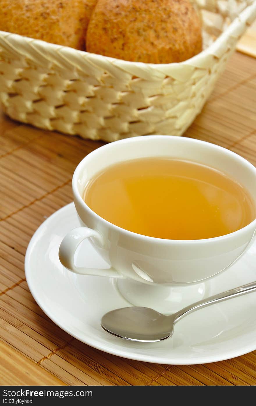 Cup of tea and a basket of bread for breakfast