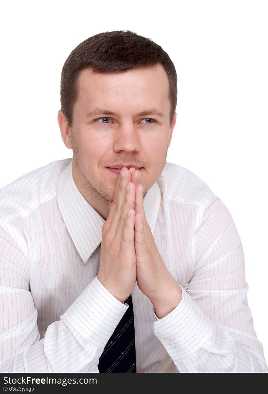 Man in a light shirt, sits with folded hands in front of him. Man in a light shirt, sits with folded hands in front of him