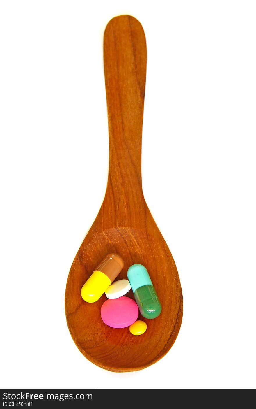 Wooden Spoon With Pills Isolated