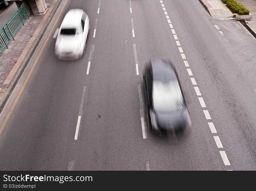 Black and white cars running on the road