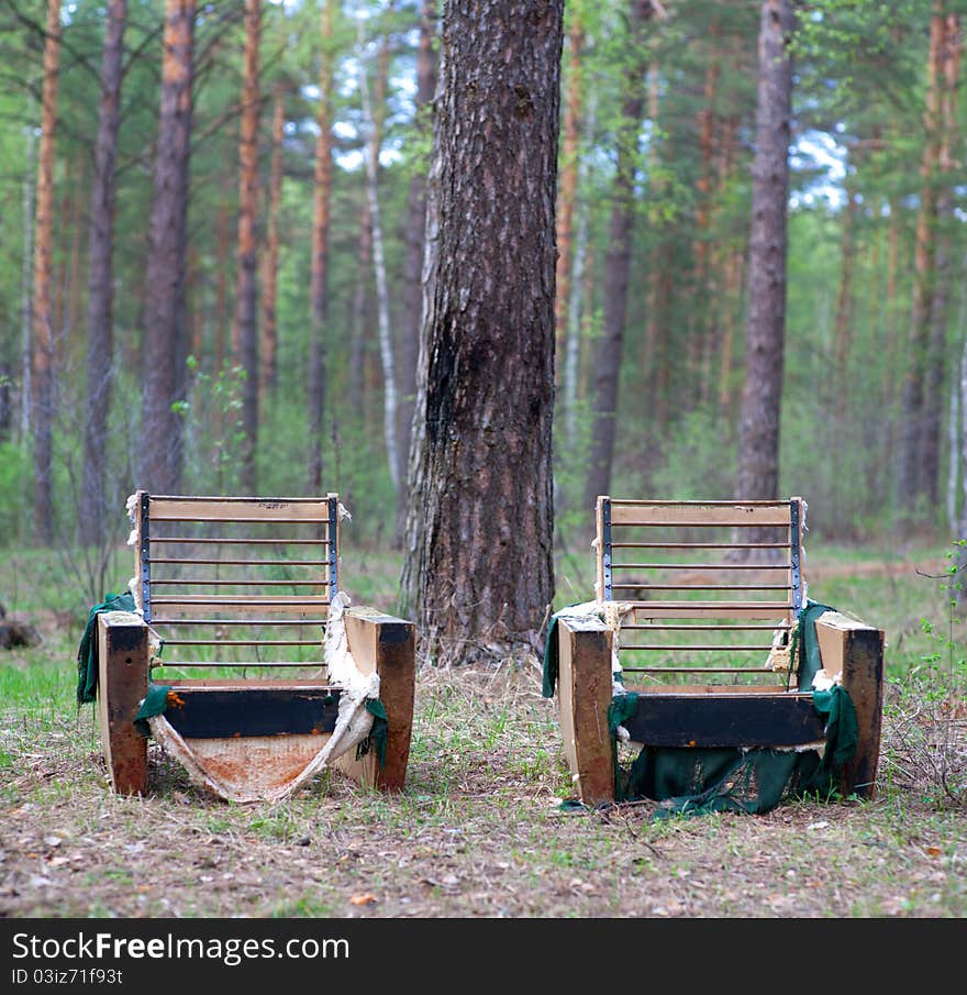 Two abandoned armchairs in wood