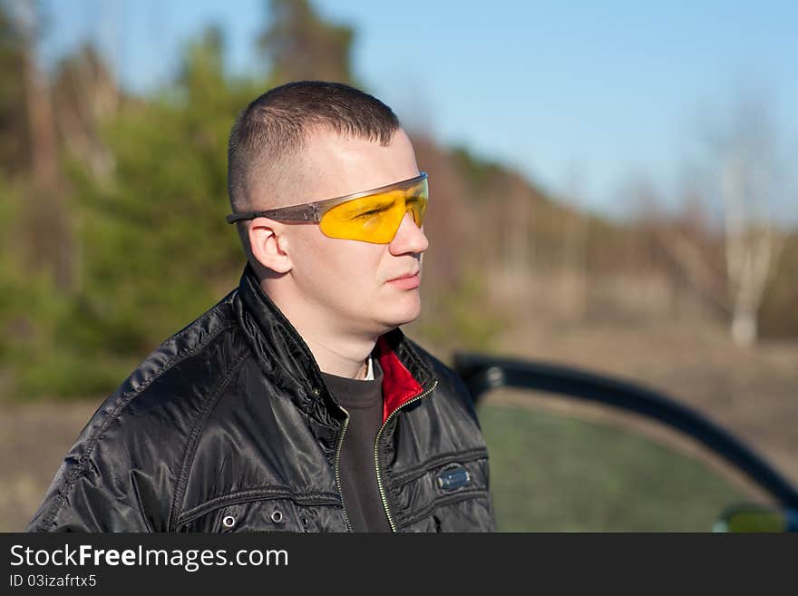 Young fashion man with attitude and modern broken glasses