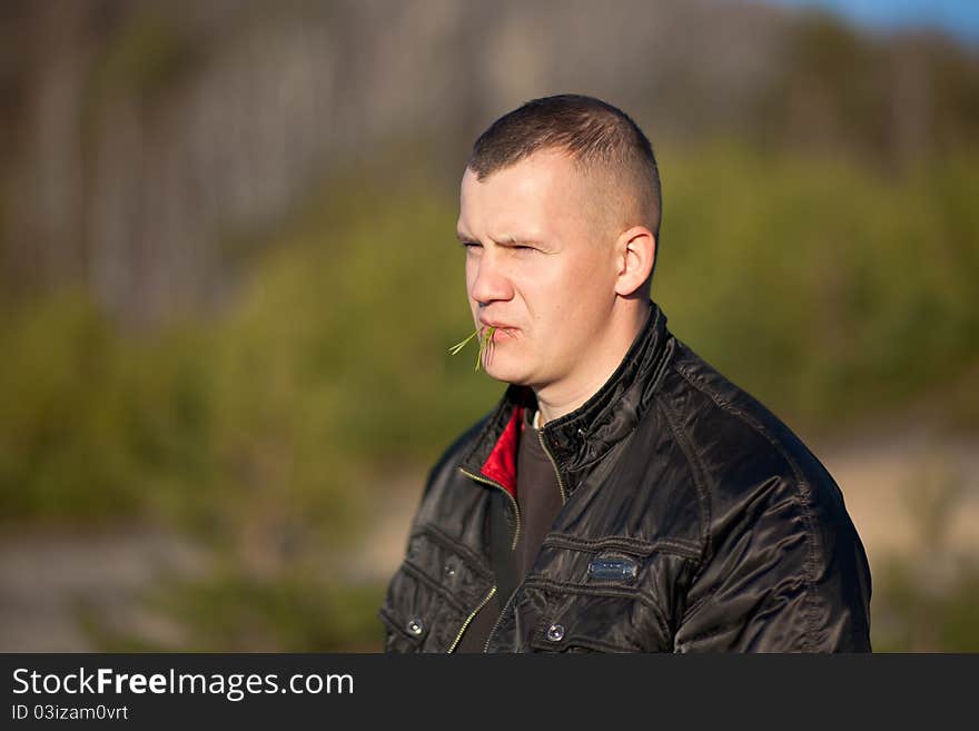 Portrait of young  man eating salad, outdoors