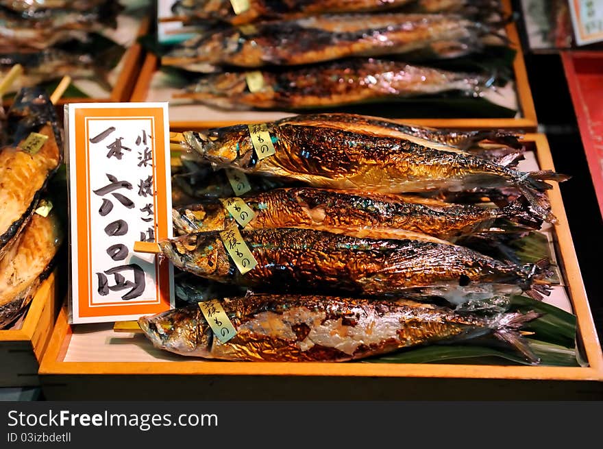 Fresh smoked fishes on counter. The tag in japanese is attached