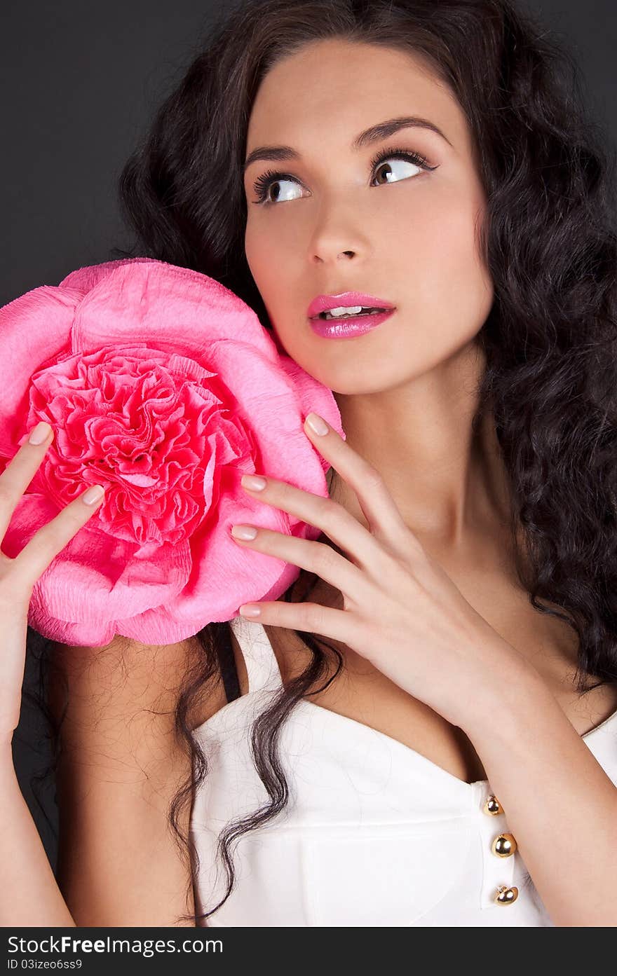 Sexy young woman with pink lipstick isolated on black