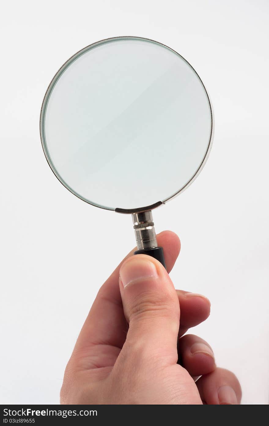 A hand holding a magnifying glass. A hand holding a magnifying glass