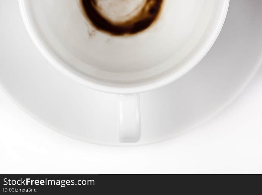 An empty white coffee cup with a stain