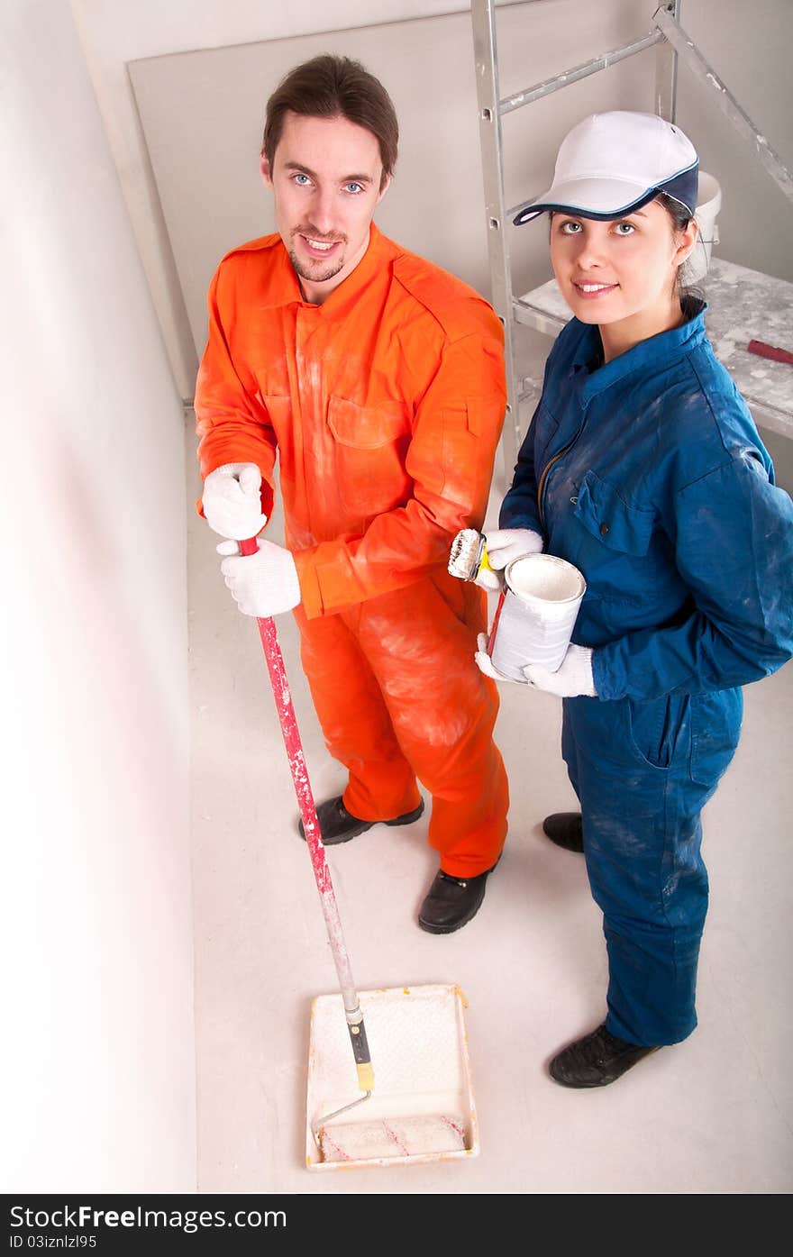 Construction workers at work, preparing to paint