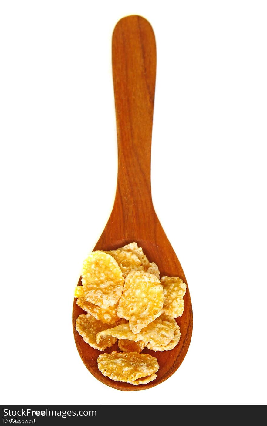 Wooden spoon with corn flakes isolated