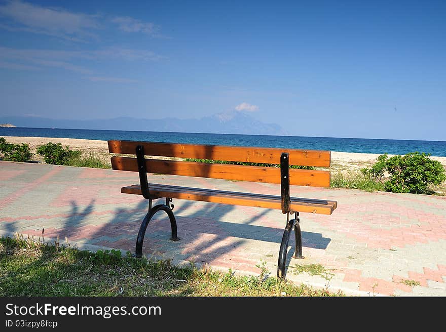 Wooden Bench On The Promenade At The Seafront