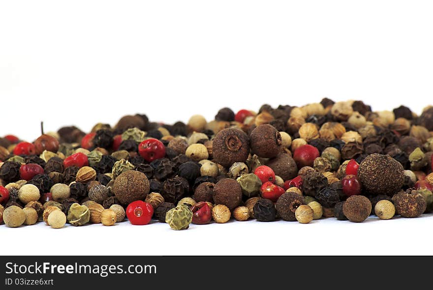 A close up of several types of peppercorns