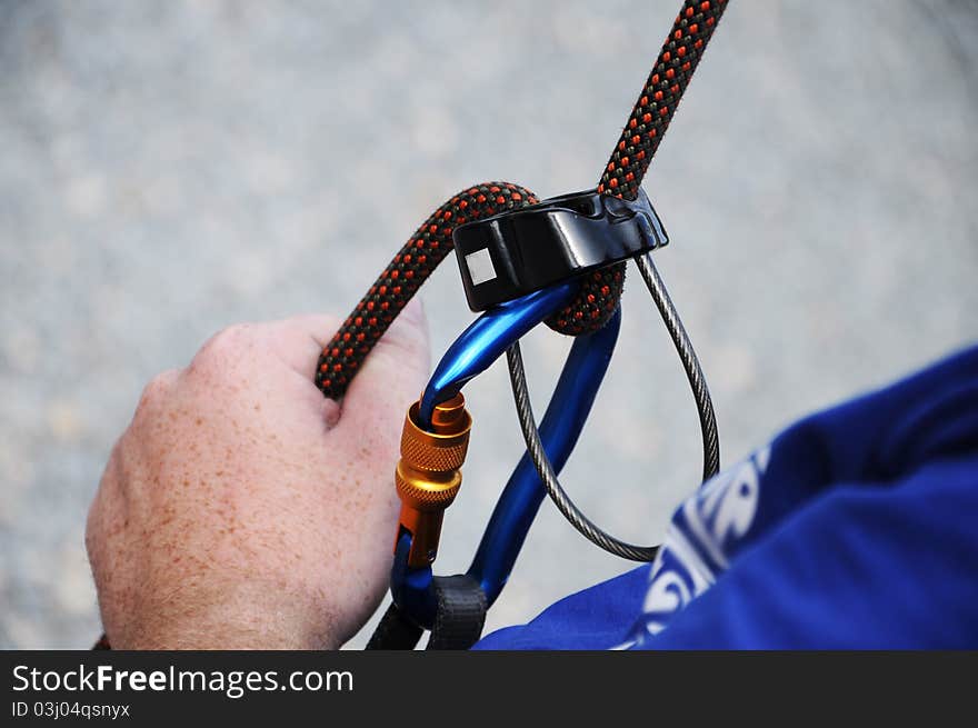 A man holding and secures a climbing rope. A man holding and secures a climbing rope.