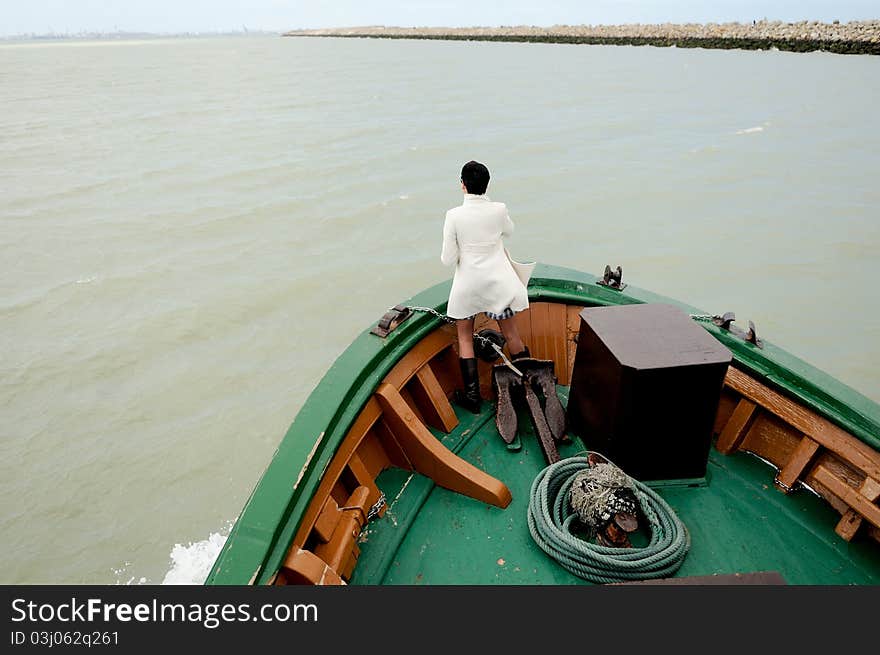 Woman in prow of a ship