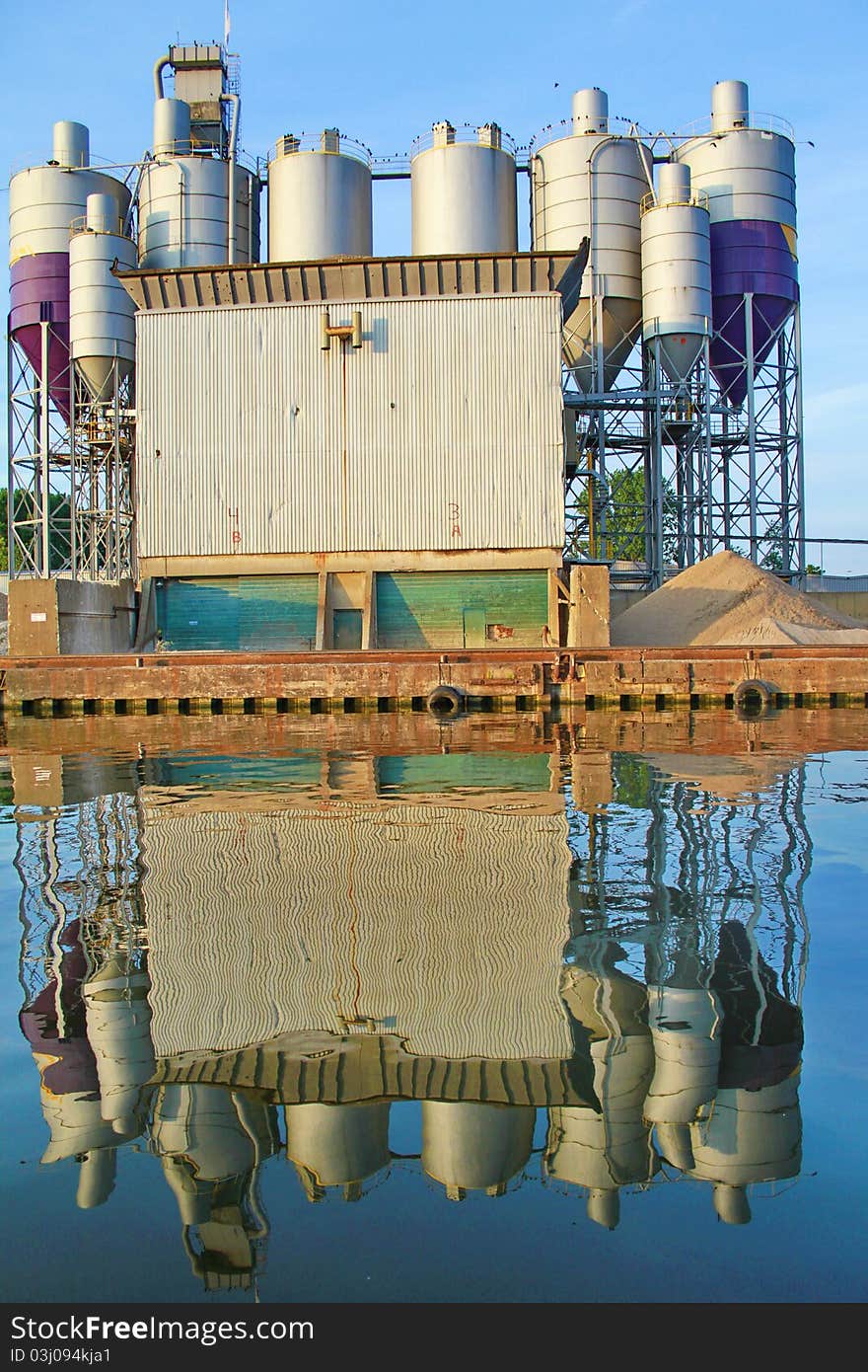 It show containers reflecting in the water. It show containers reflecting in the water