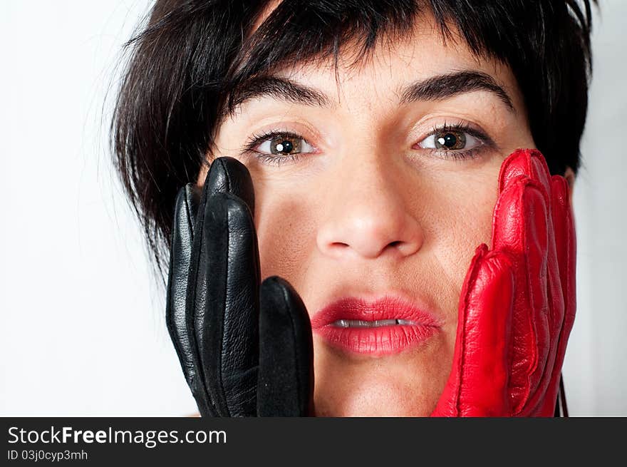 A girl with red and black gloves with a look of surprise.