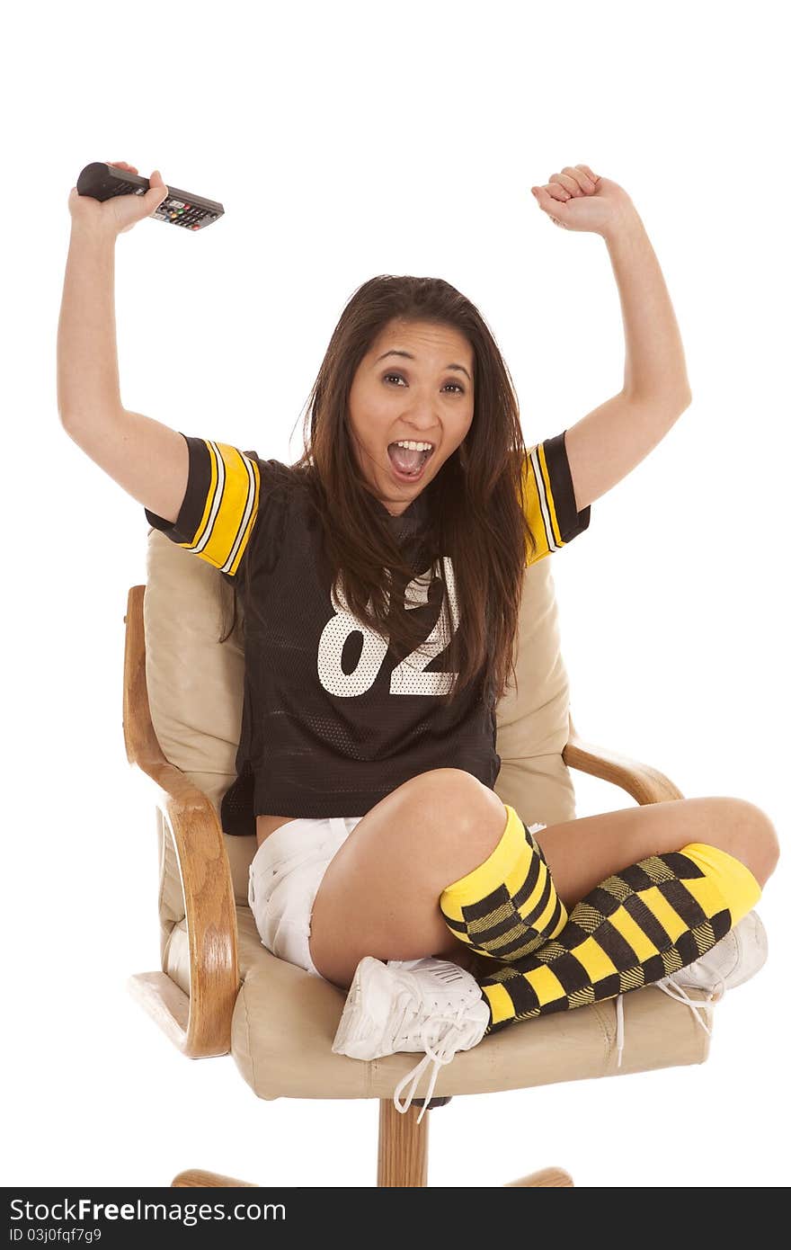 A woman in her football jersey excited about the game. A woman in her football jersey excited about the game.