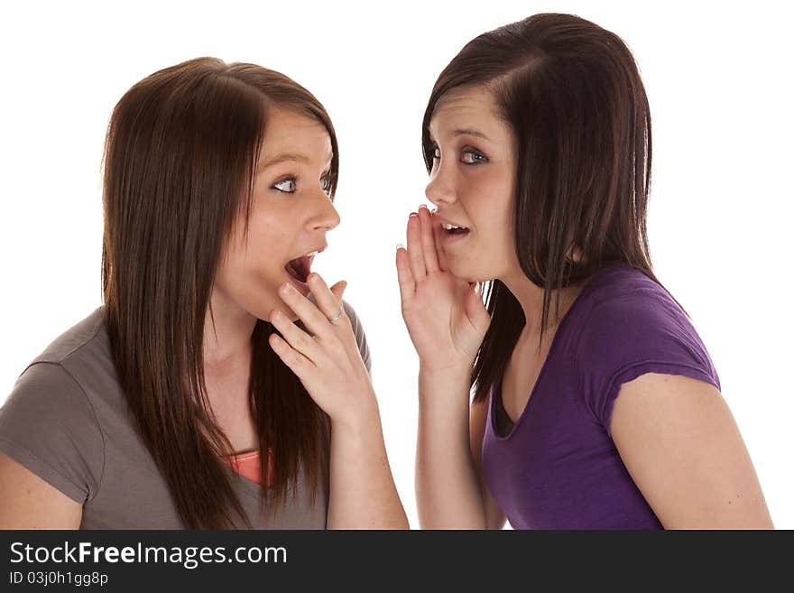 A teen is telling her friend a secret and she is shocked.