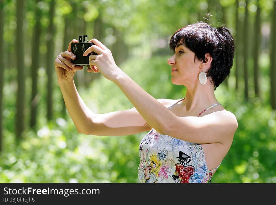 Woman taking a selfportrait with a old camera