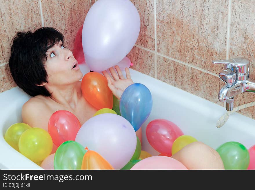 Woman playing with balloons in his bathtub. Woman playing with balloons in his bathtub