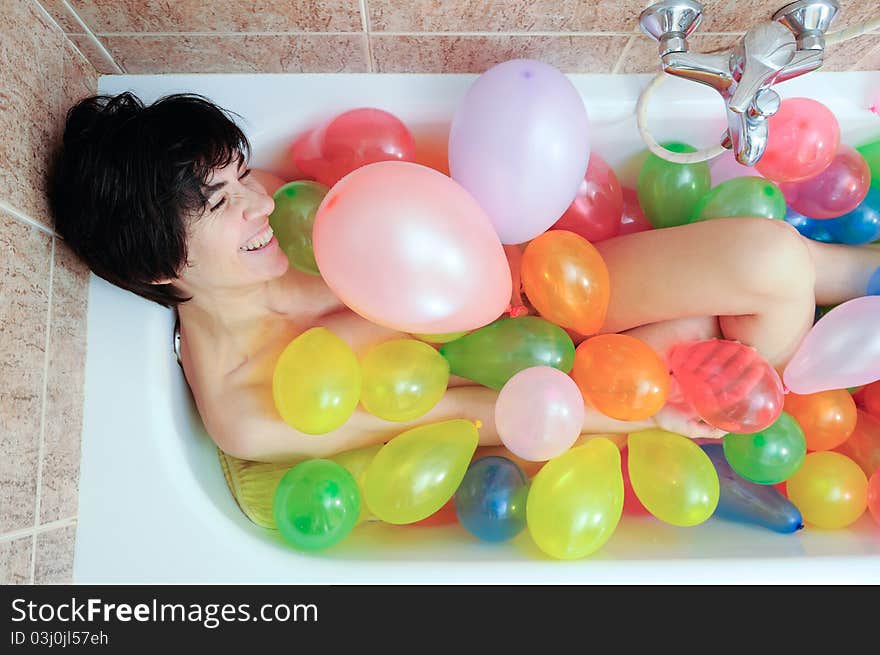 Woman playing with balloons in his bathtub. Woman playing with balloons in his bathtub