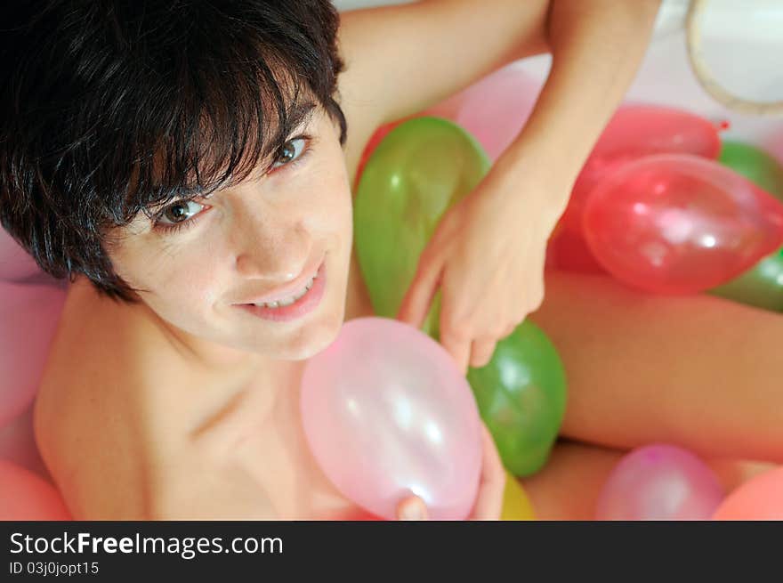 Woman playing with balloons in his bathtub. Woman playing with balloons in his bathtub