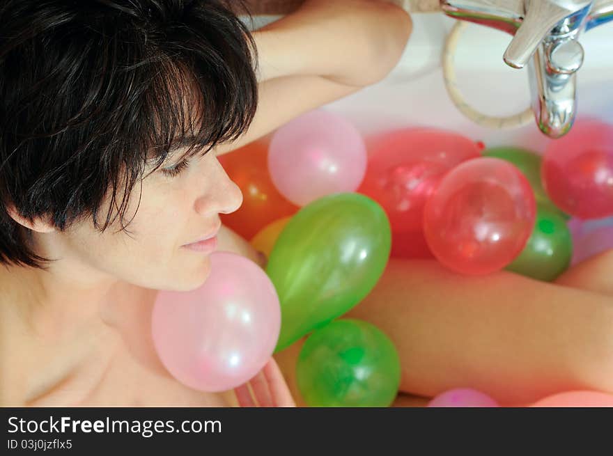 Woman playing with balloons in his bathtub. Woman playing with balloons in his bathtub