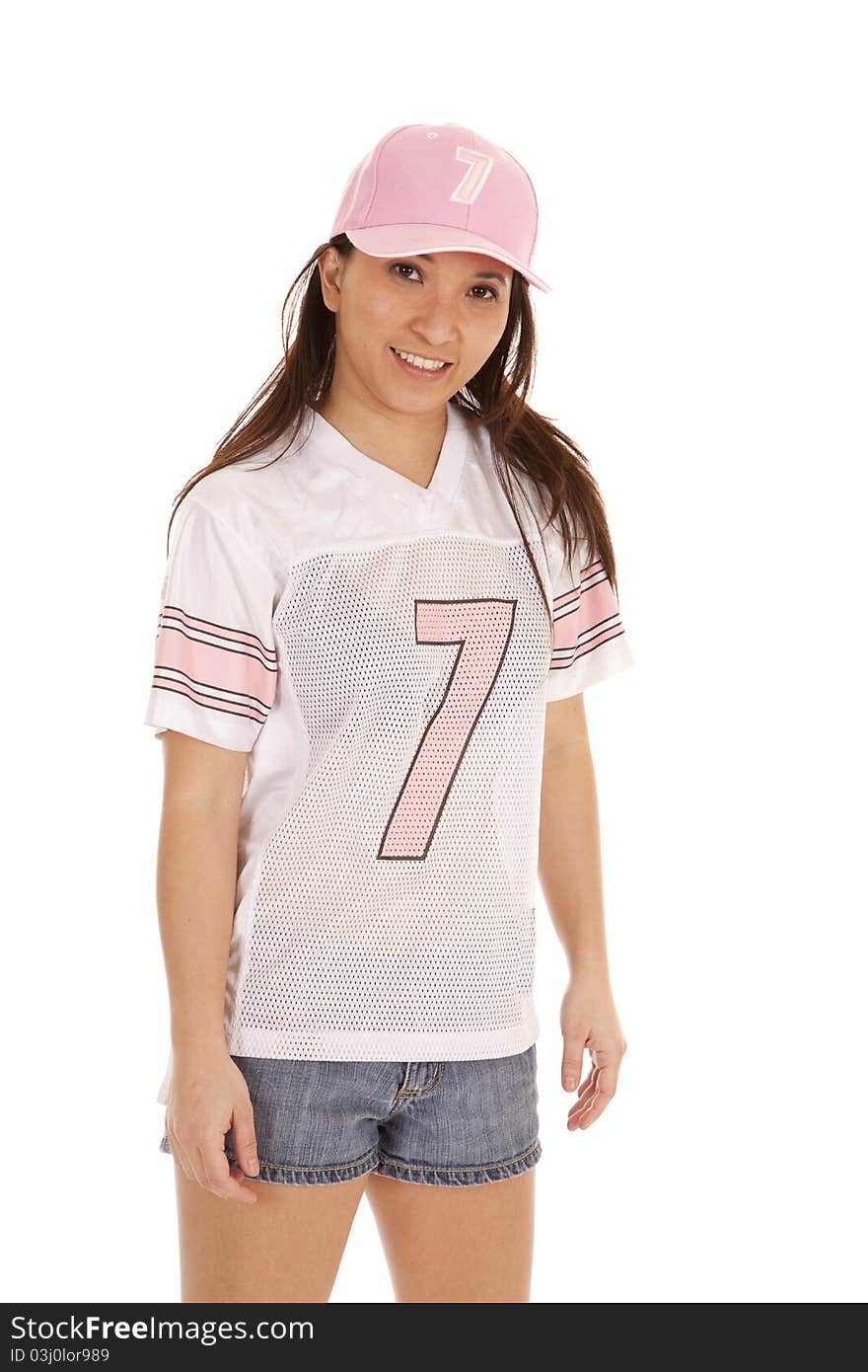 A woman showing her big smile in her football jersey. A woman showing her big smile in her football jersey.