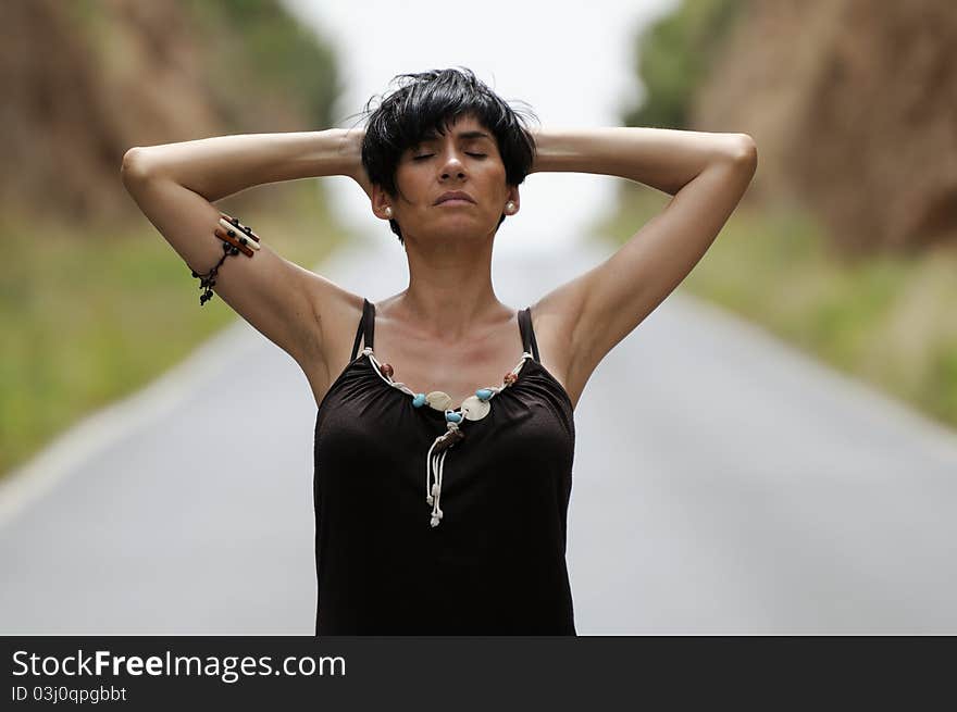 Woman on the road with eyes closed