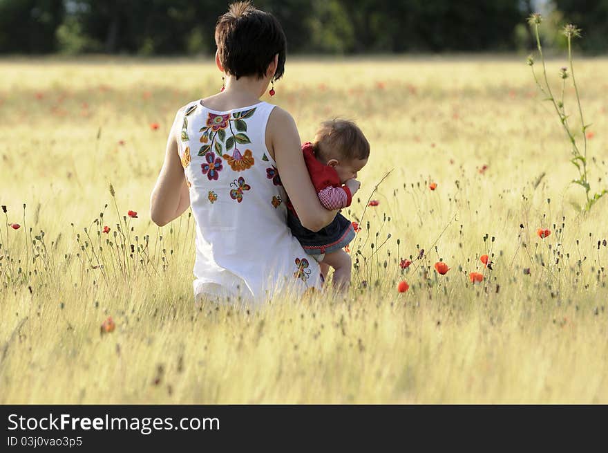 Mother and daughter in a poppy field