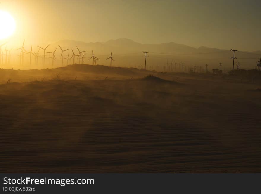 Windmills and Blowing Sand at Sunset near Palm Springs, CA. Windmills and Blowing Sand at Sunset near Palm Springs, CA