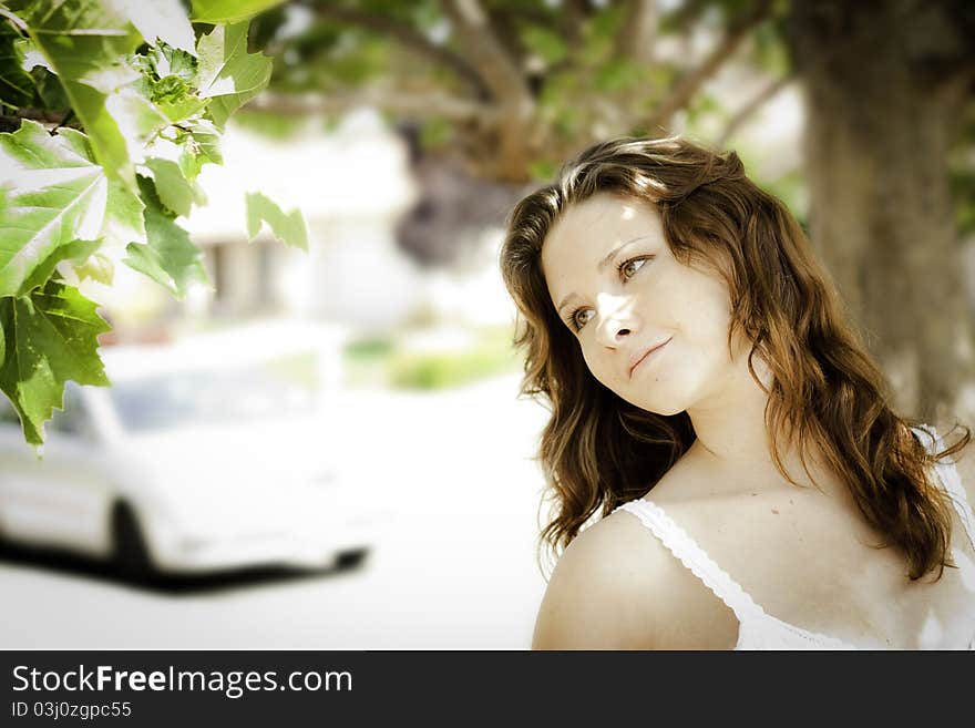 A young woman outdoors lost in thought and enjoying nature!. A young woman outdoors lost in thought and enjoying nature!