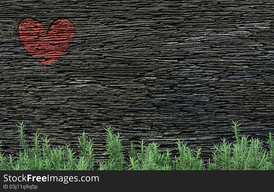 A rock layered wall with red heart. A rock layered wall with red heart