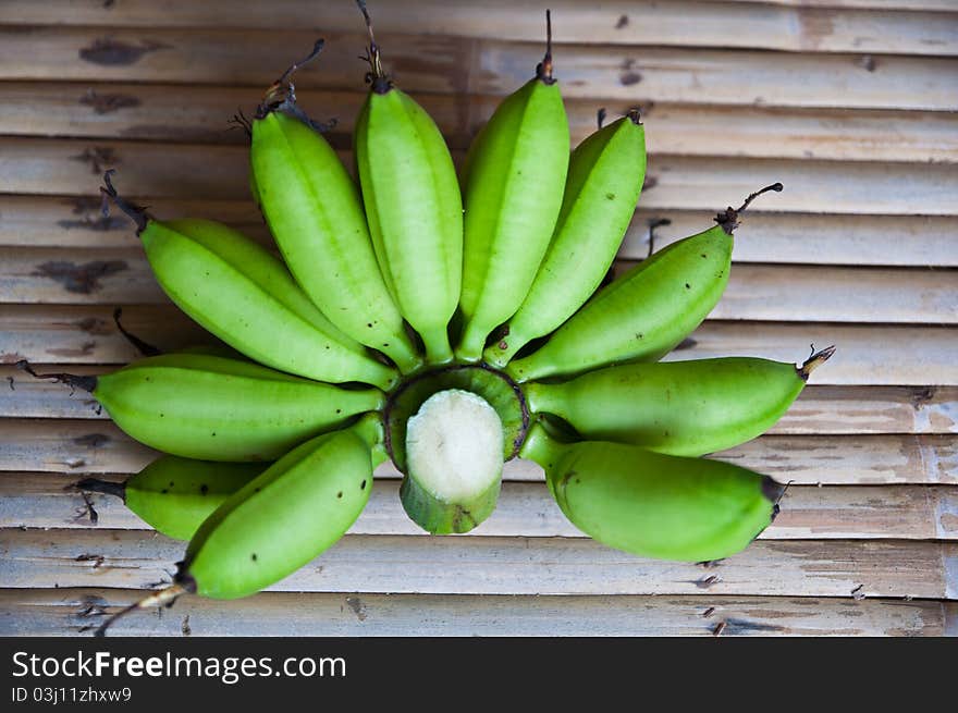 Young banana cut from tree on bamboo table. Young banana cut from tree on bamboo table