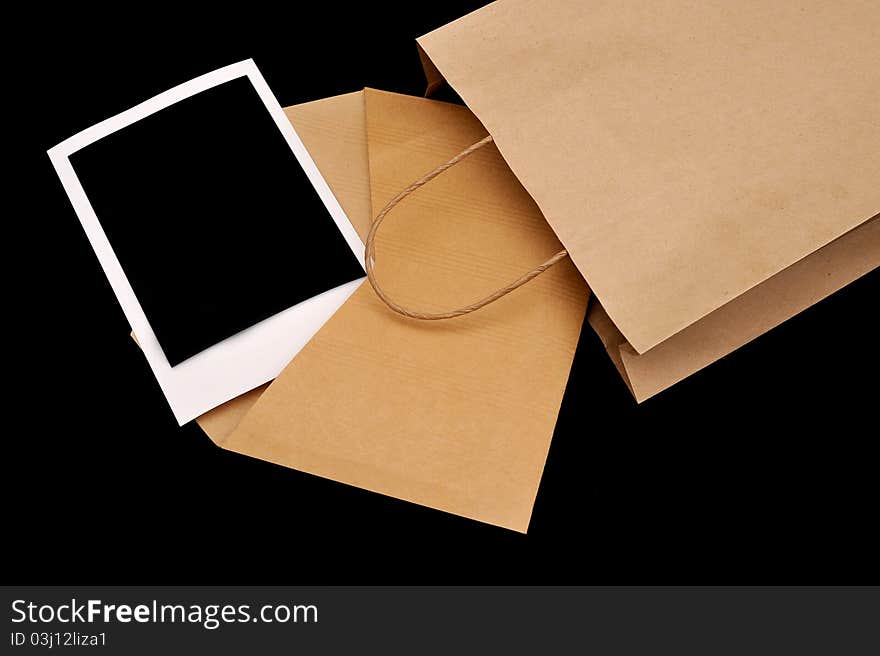 A vintage envelope in a paper bag with instant photo inside. A vintage envelope in a paper bag with instant photo inside