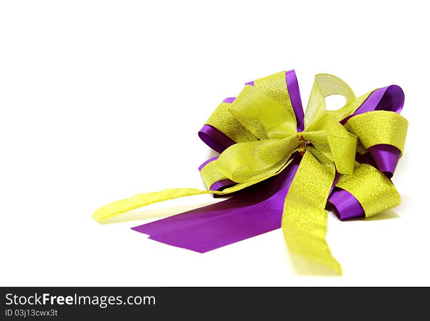 Gold and violet ribbon bow isolated on white background.