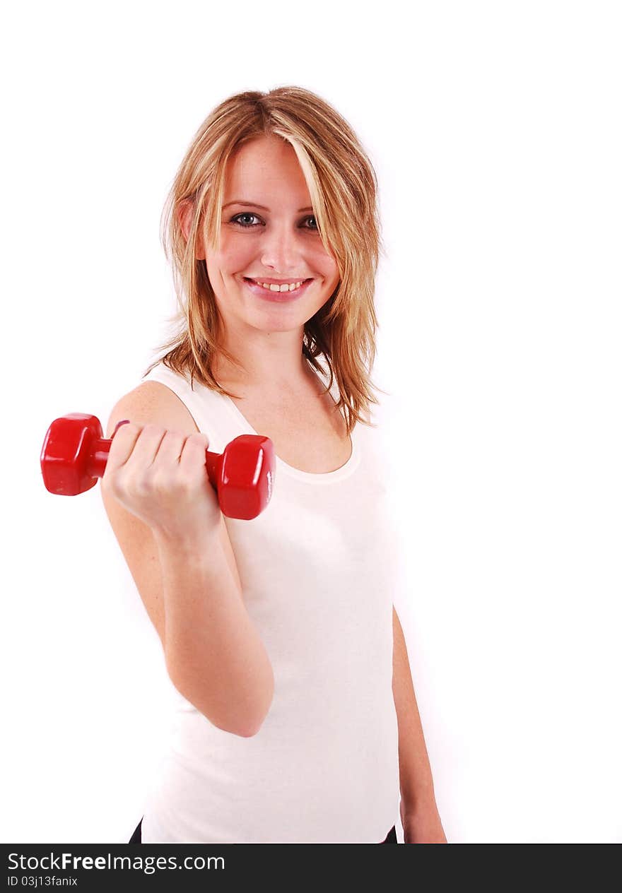 Exercising young woman in white shirt with red fitness weights