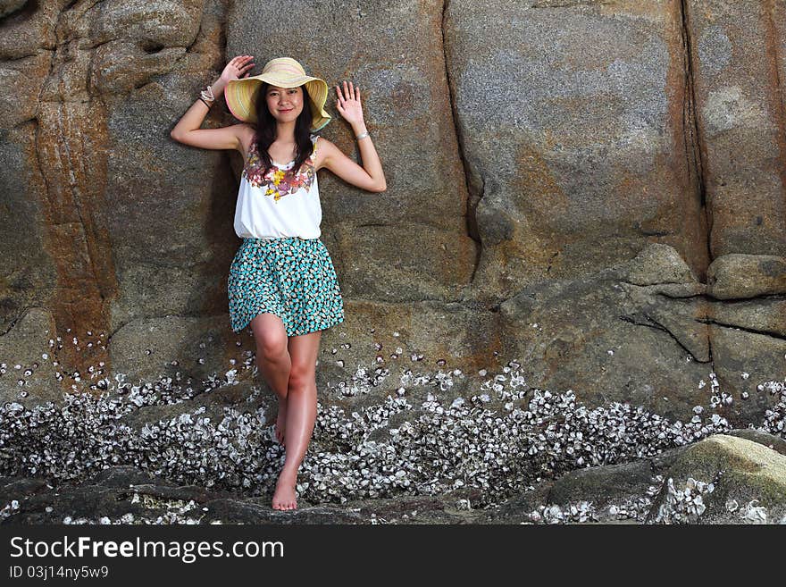 Beautiful Young Woman Posing On Stones Near Sea