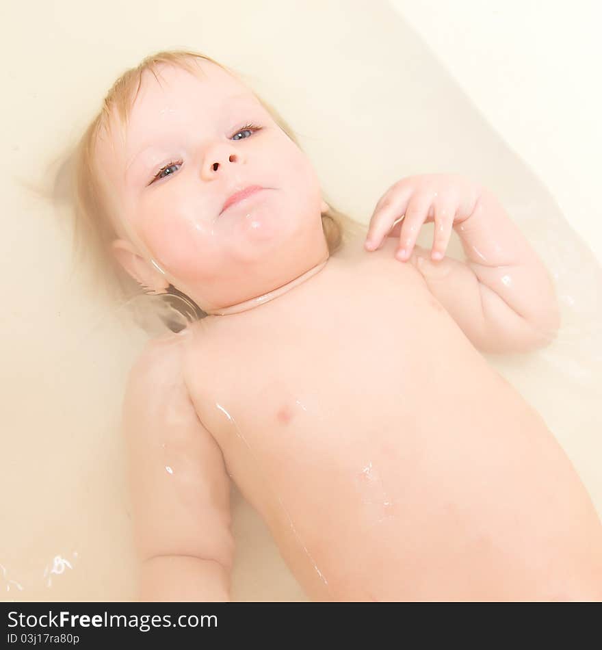 Adorable baby taking bath and swim