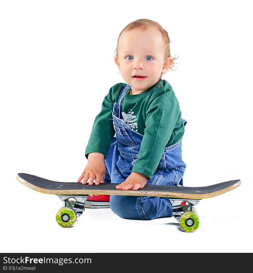 Cute 1 years old boy on a skateboard in the studio. Cute 1 years old boy on a skateboard in the studio