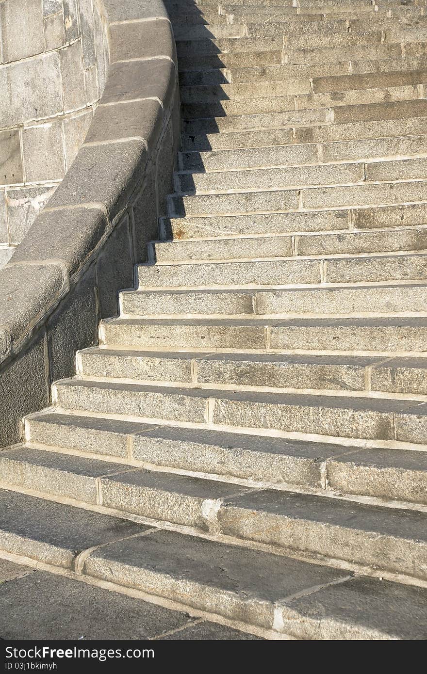 Granite curve modern stairs with stone handrail. Granite curve modern stairs with stone handrail