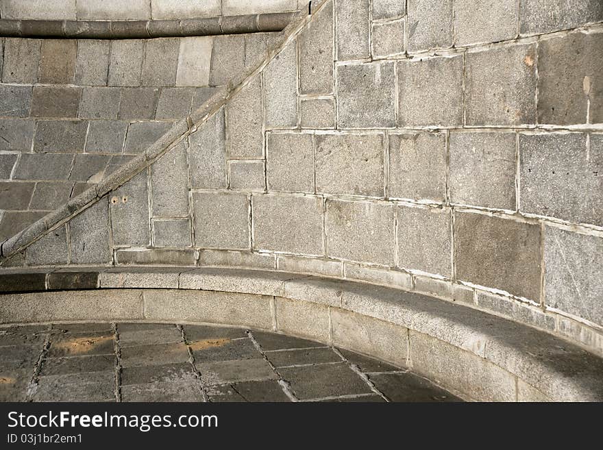 Close-up curve section of a granite stone wall and floor background